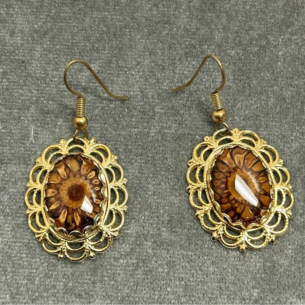 Gold tone flower cat eye oval dangling earrings